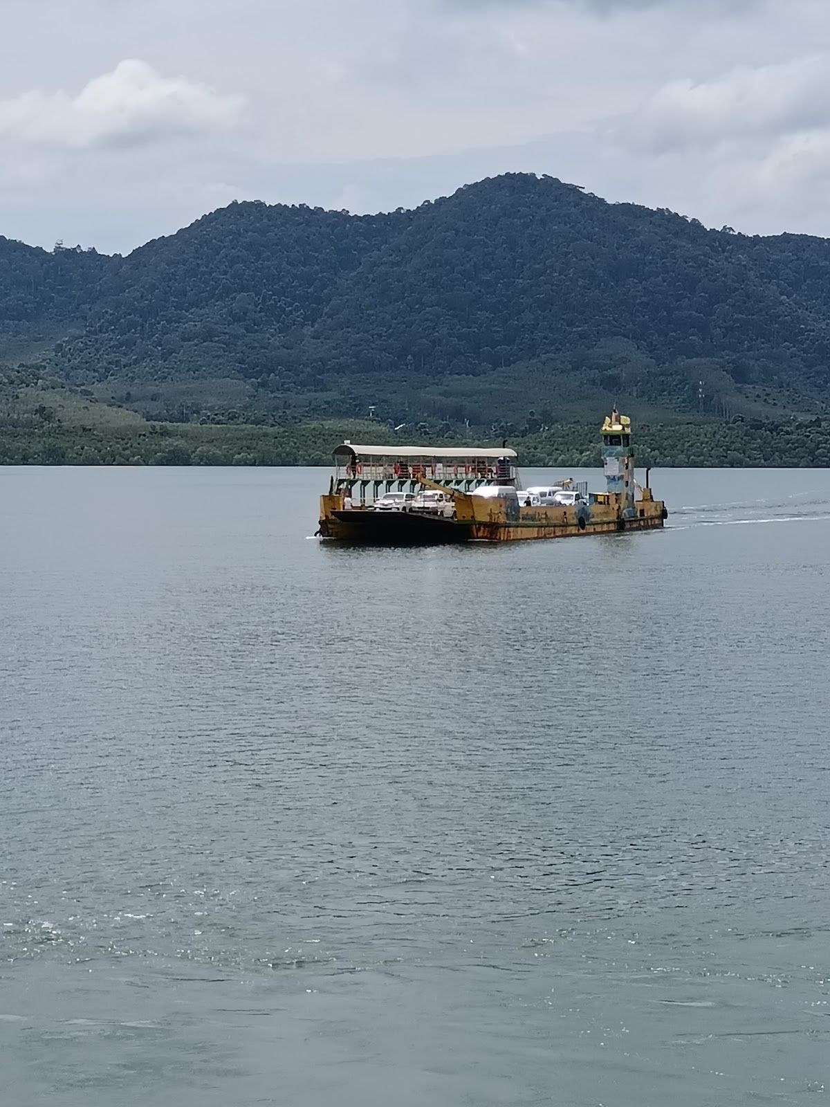 The vehicle ferry at Ban Hua Hin pier — every minivan to Koh Lanta drives onto one of these. The crossing takes 10–15 minutes. The vehicle car ferry crossing between the mainland and Koh Lanta Noi near Ban Hua Hin pier