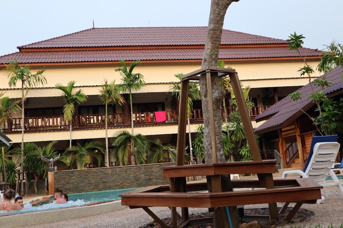 Klong Muang Beach in Krabi with a resort hotel beachfront, calm water and limestone karsts visible offshore